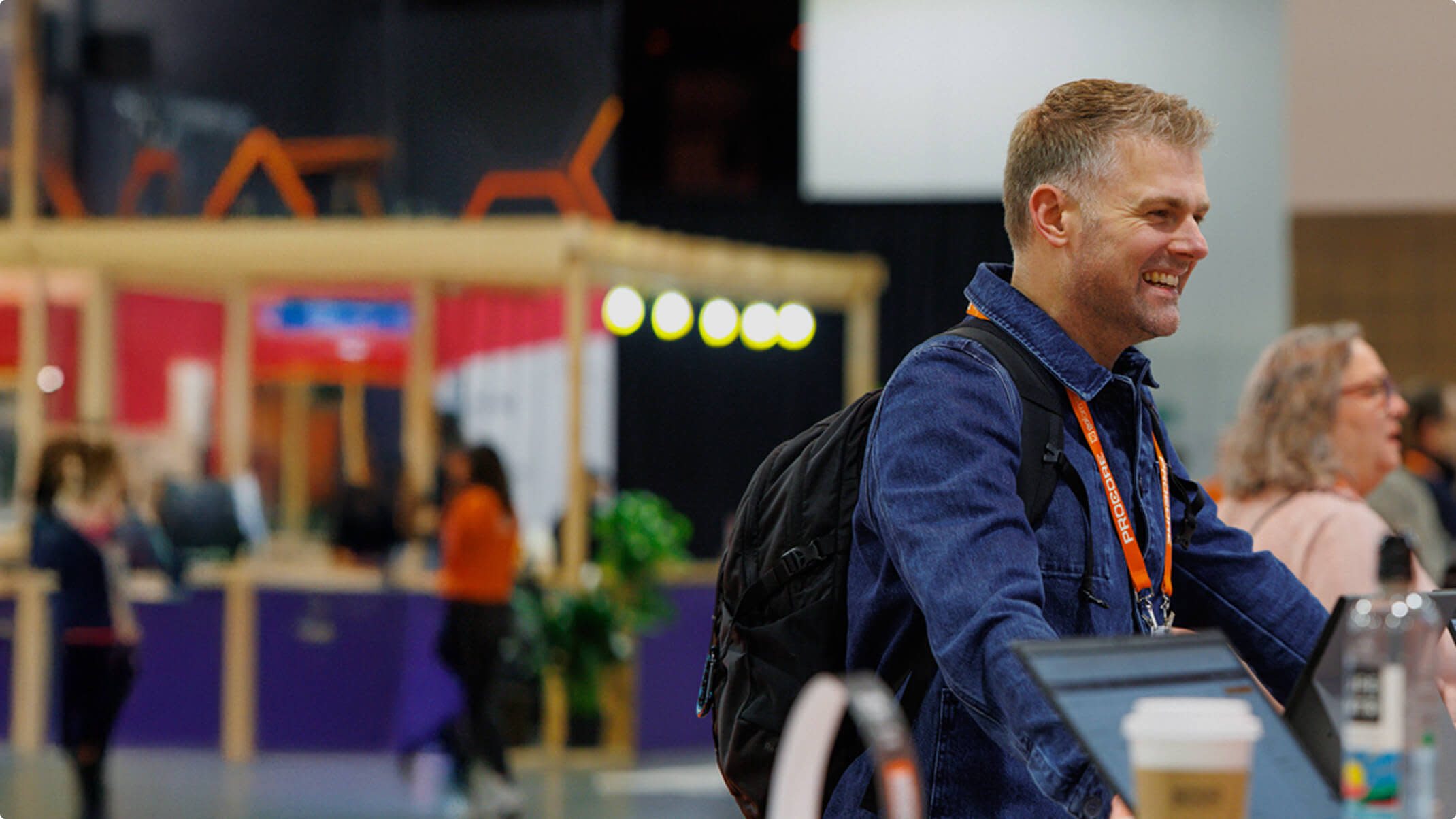 Groundbreak attendee getting having a conversation at a booth