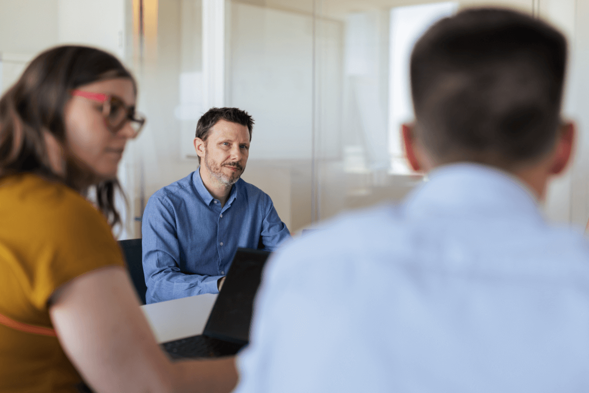 Workers discussing projects at a desk