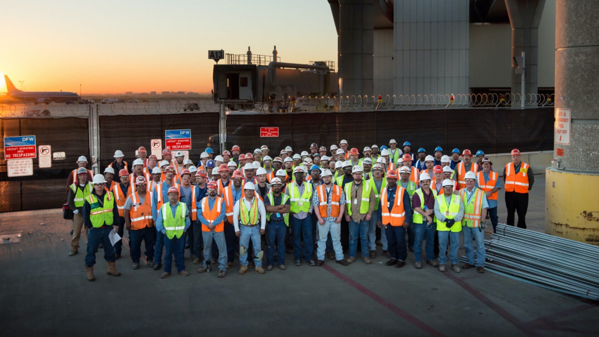 DFW Airport Terminal with a large group standing for a photo