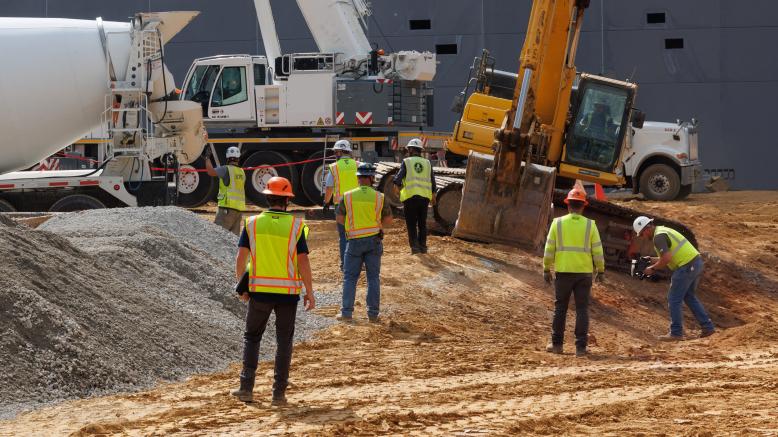 Contractors working on a civil construction site with heavy equipment