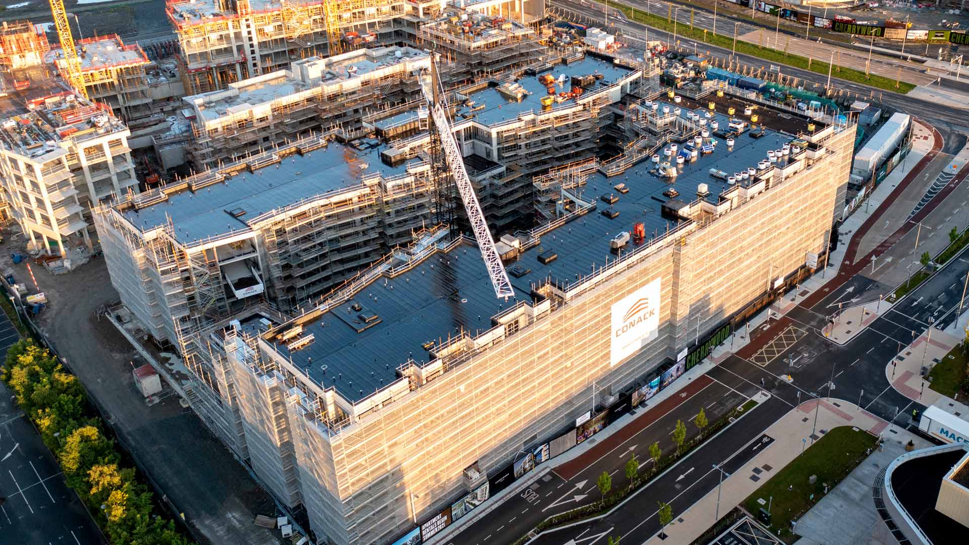 Aerial view of a large building under construction by Conack