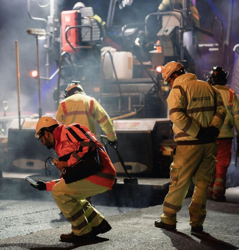 Construction workers pouring concrete