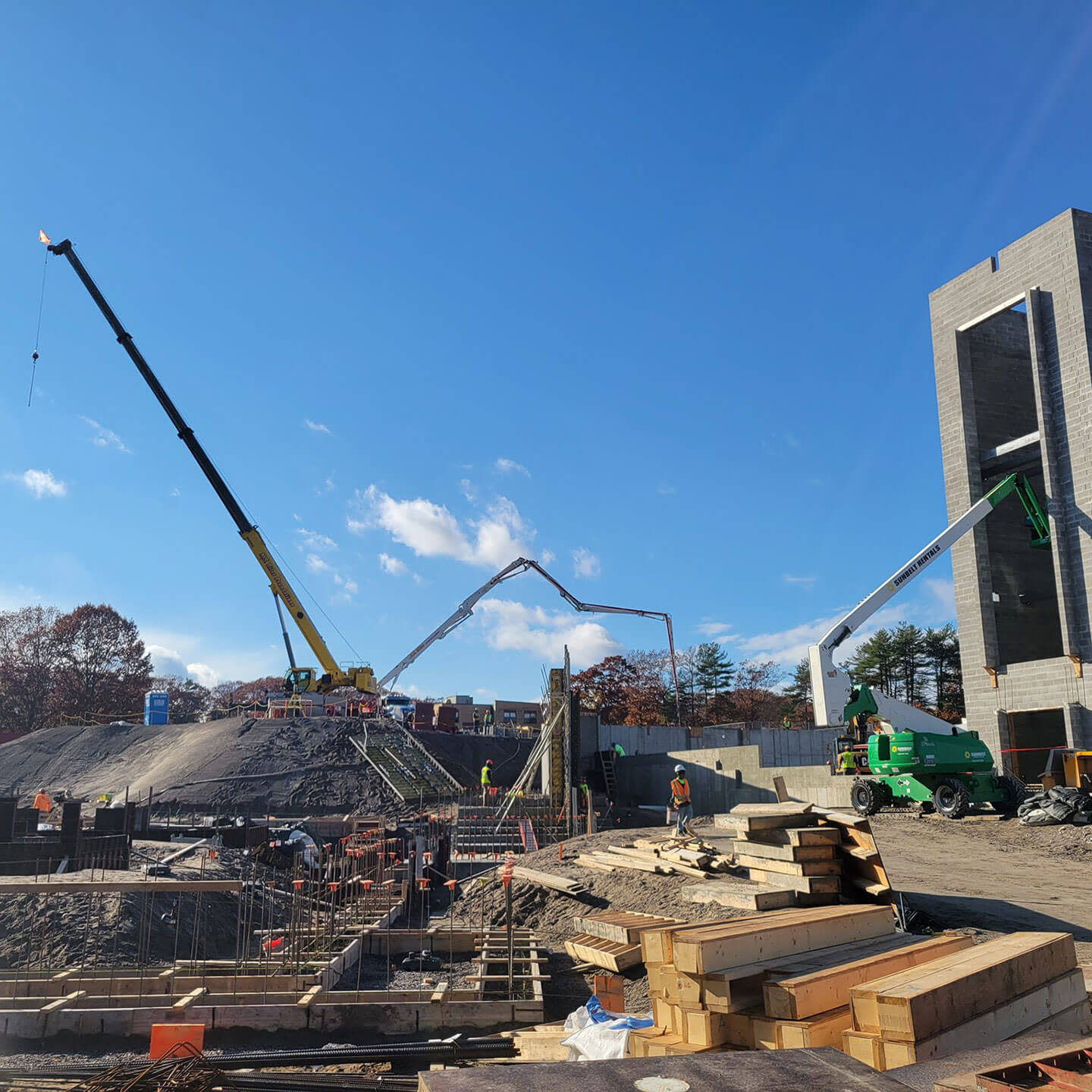 A construction site with the workers and machinery on it