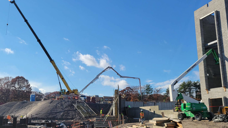 A construction site with the workers and machinery on it