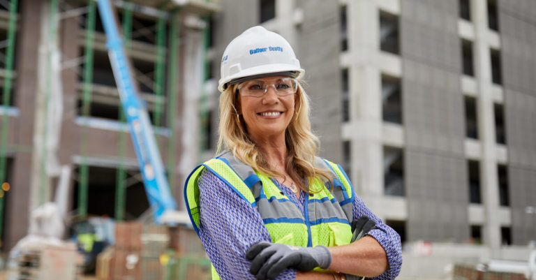 Kasey Bevans posing in front of a construction site