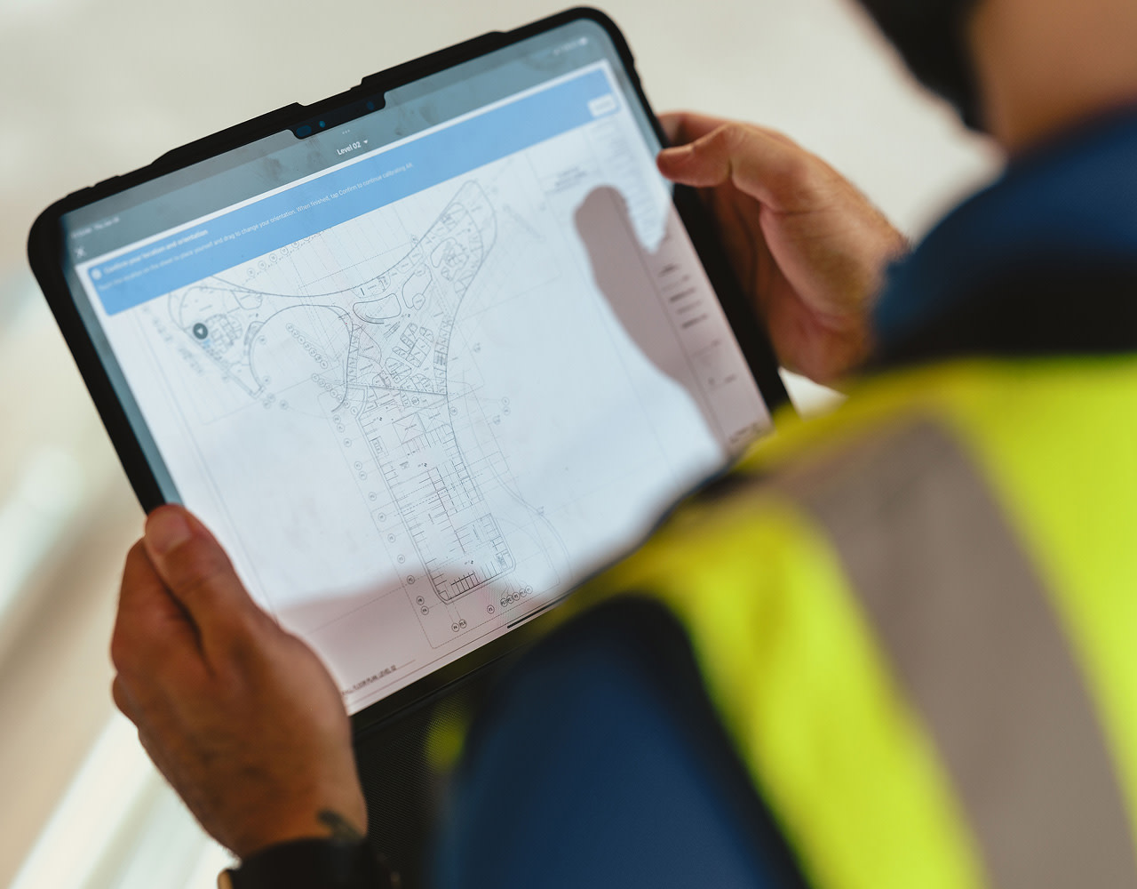 Close up of a contractor using a tablet