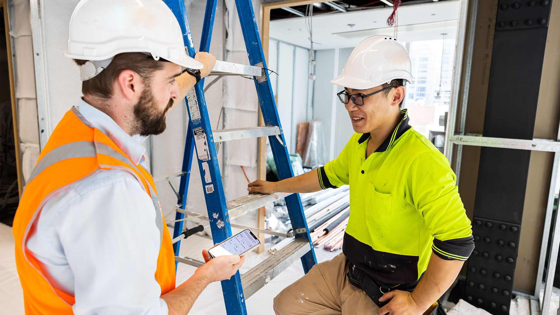 Two men having a conversation on a construction site