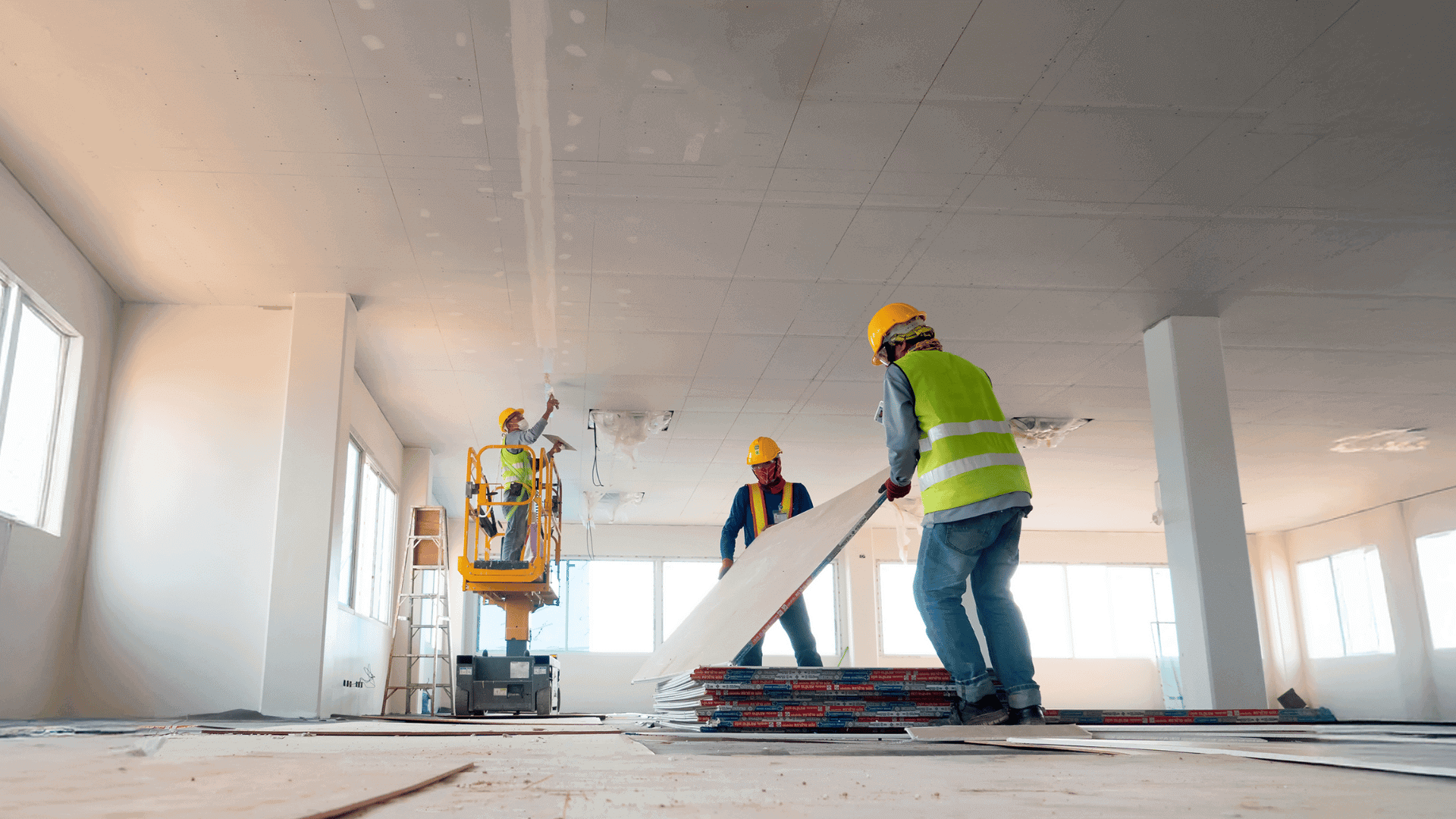 Three construction workers working on site