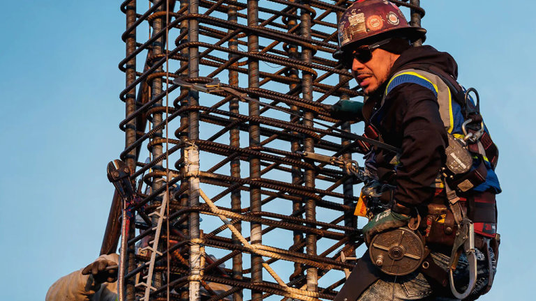 A construction worker standing on a metal structure