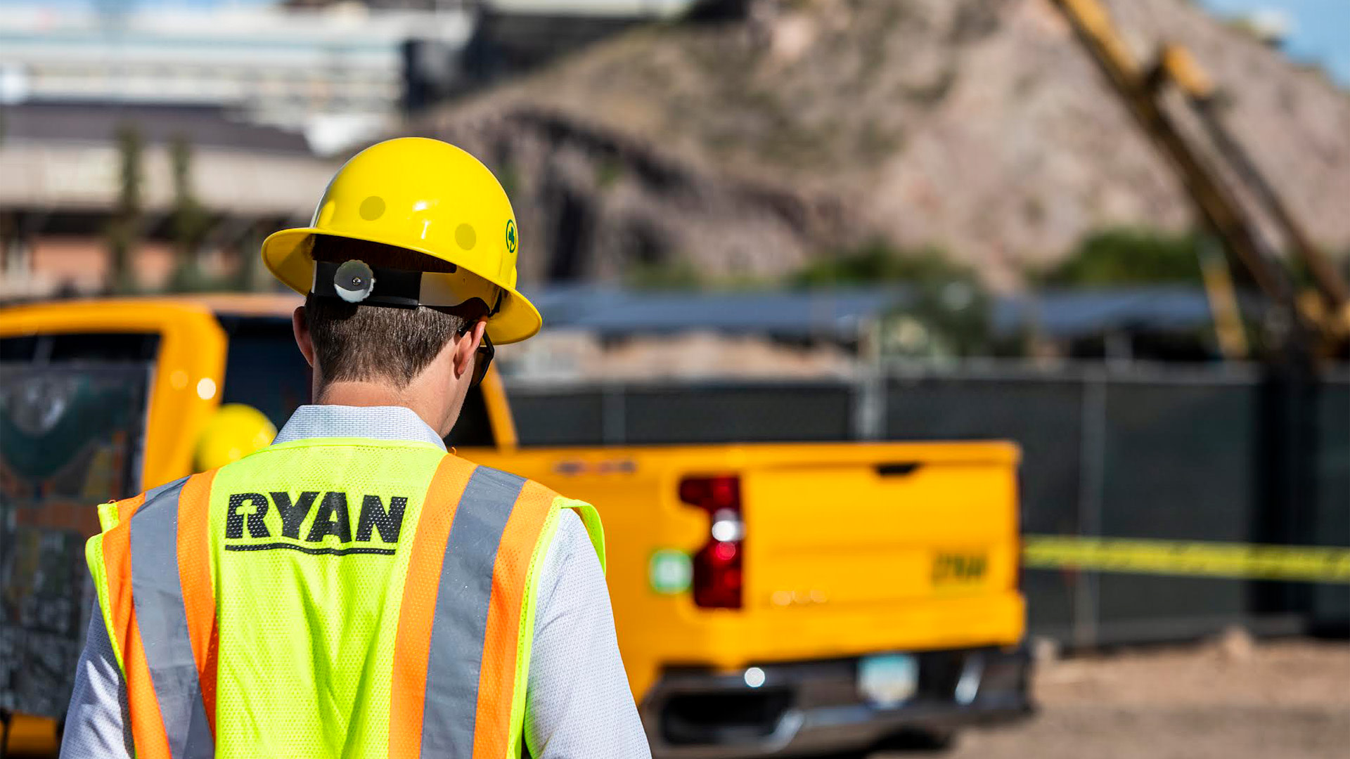 a Ryan Companies contractor walking towards a truck