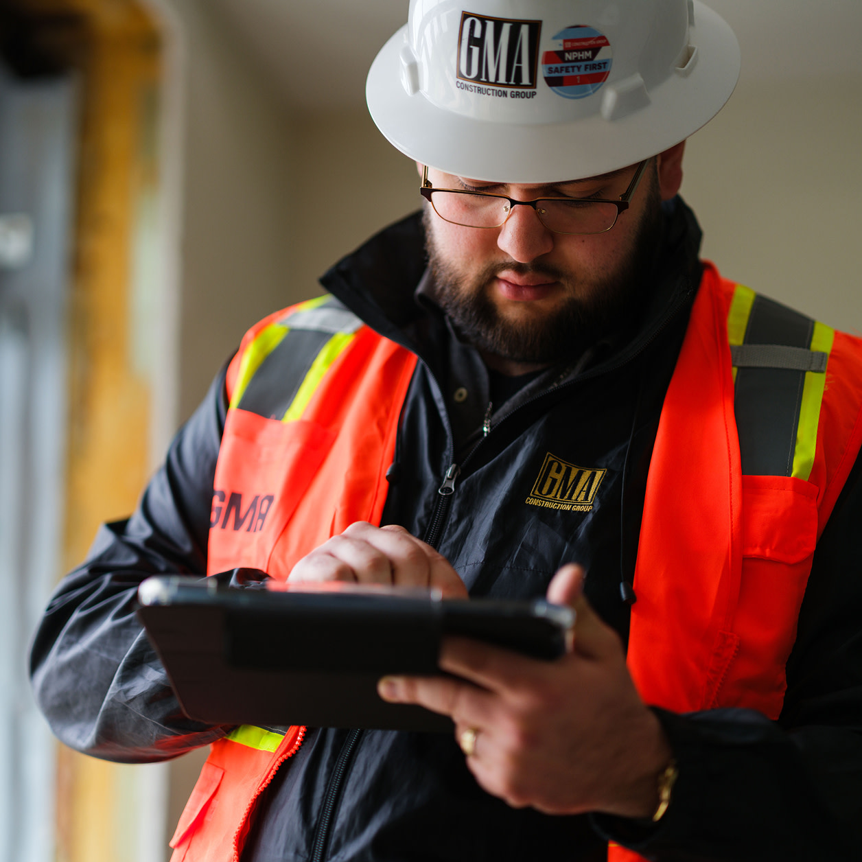 A construction worker using a tablet at a construction site