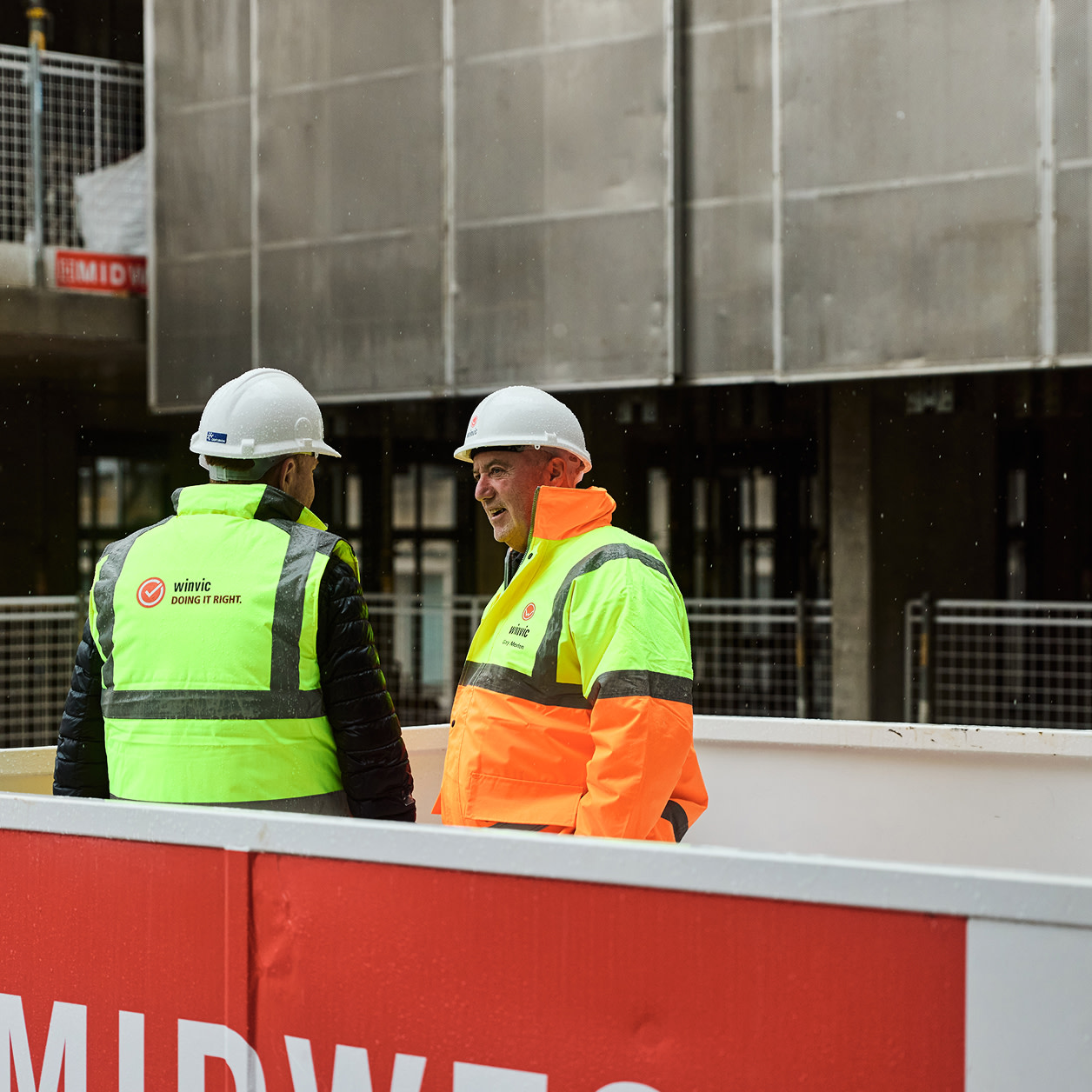 A construction worker using a tablet at a construction site