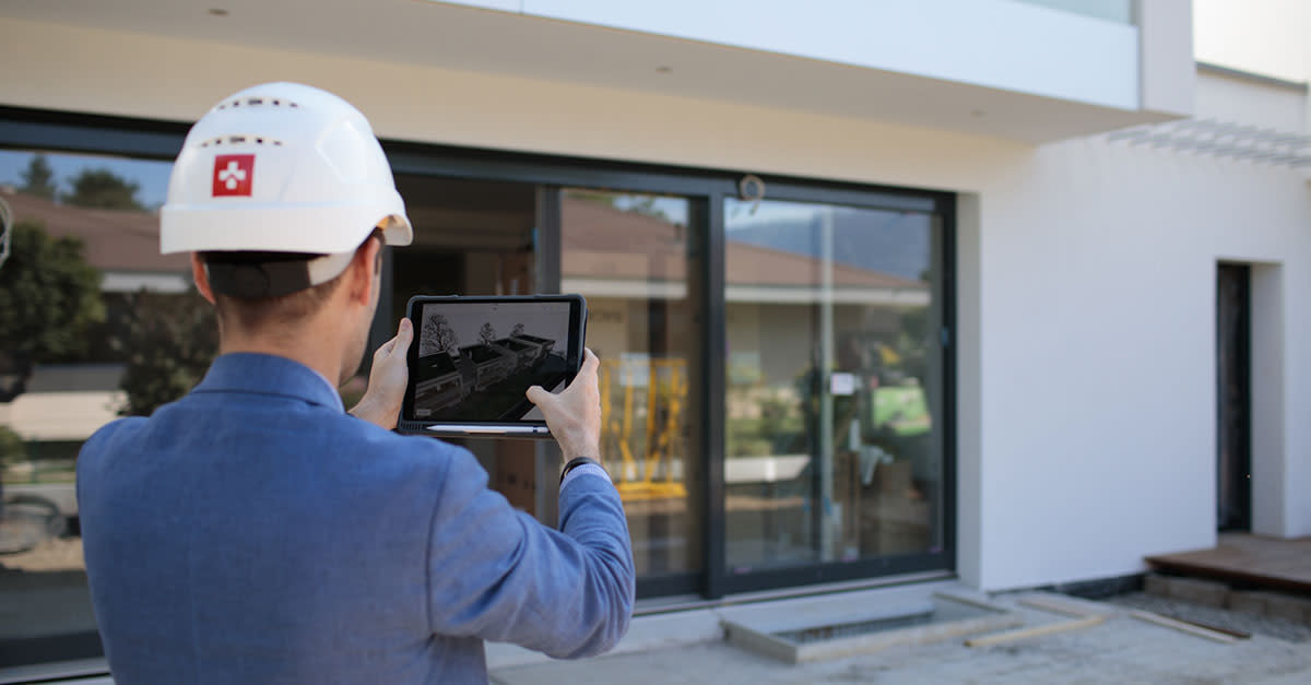 Swissroc worker using Procore on a tabler