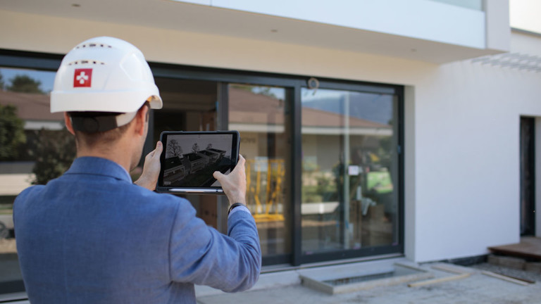 Swissroc worker using Procore on a tabler