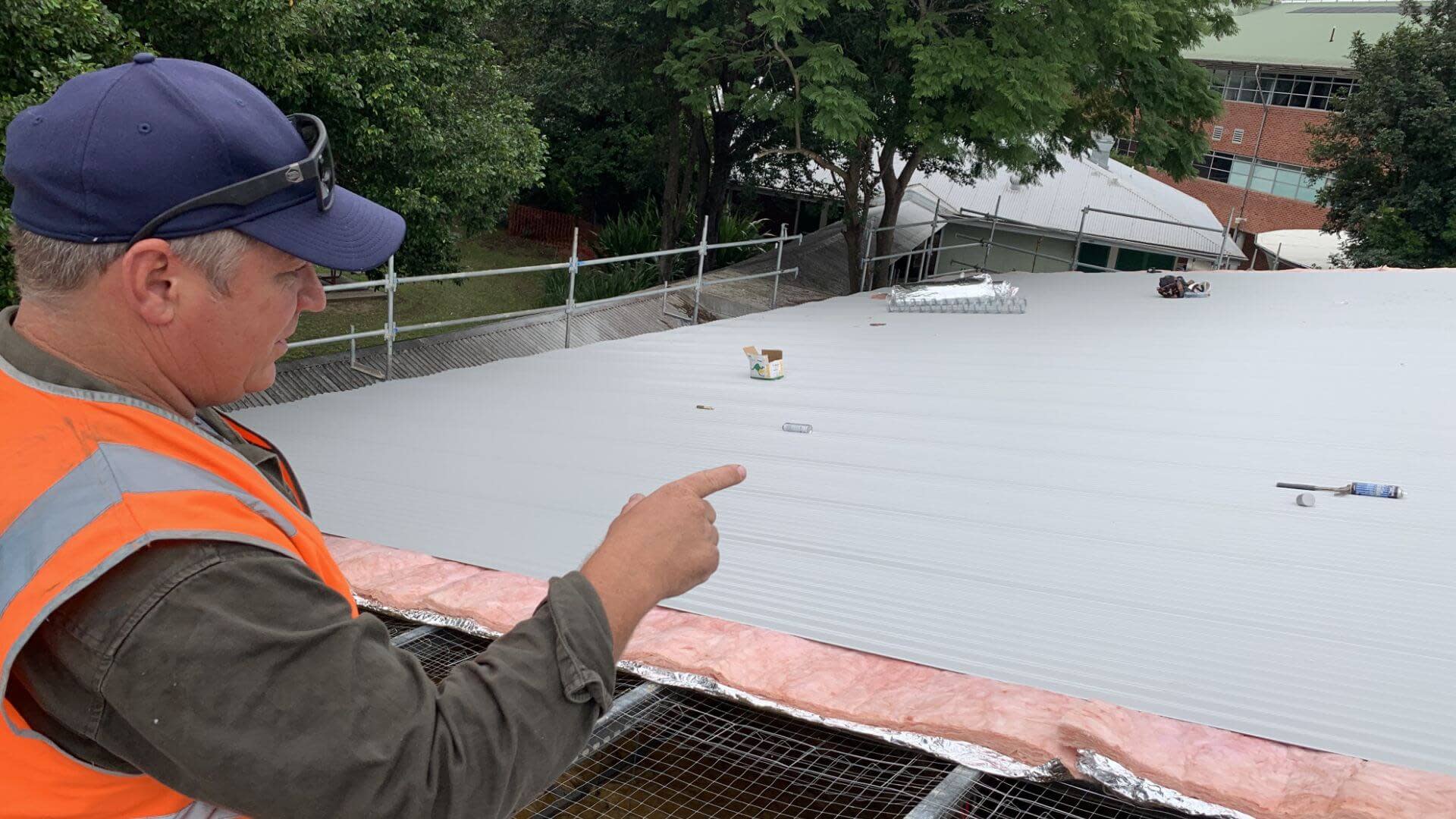 Construction worker inspecting a roof