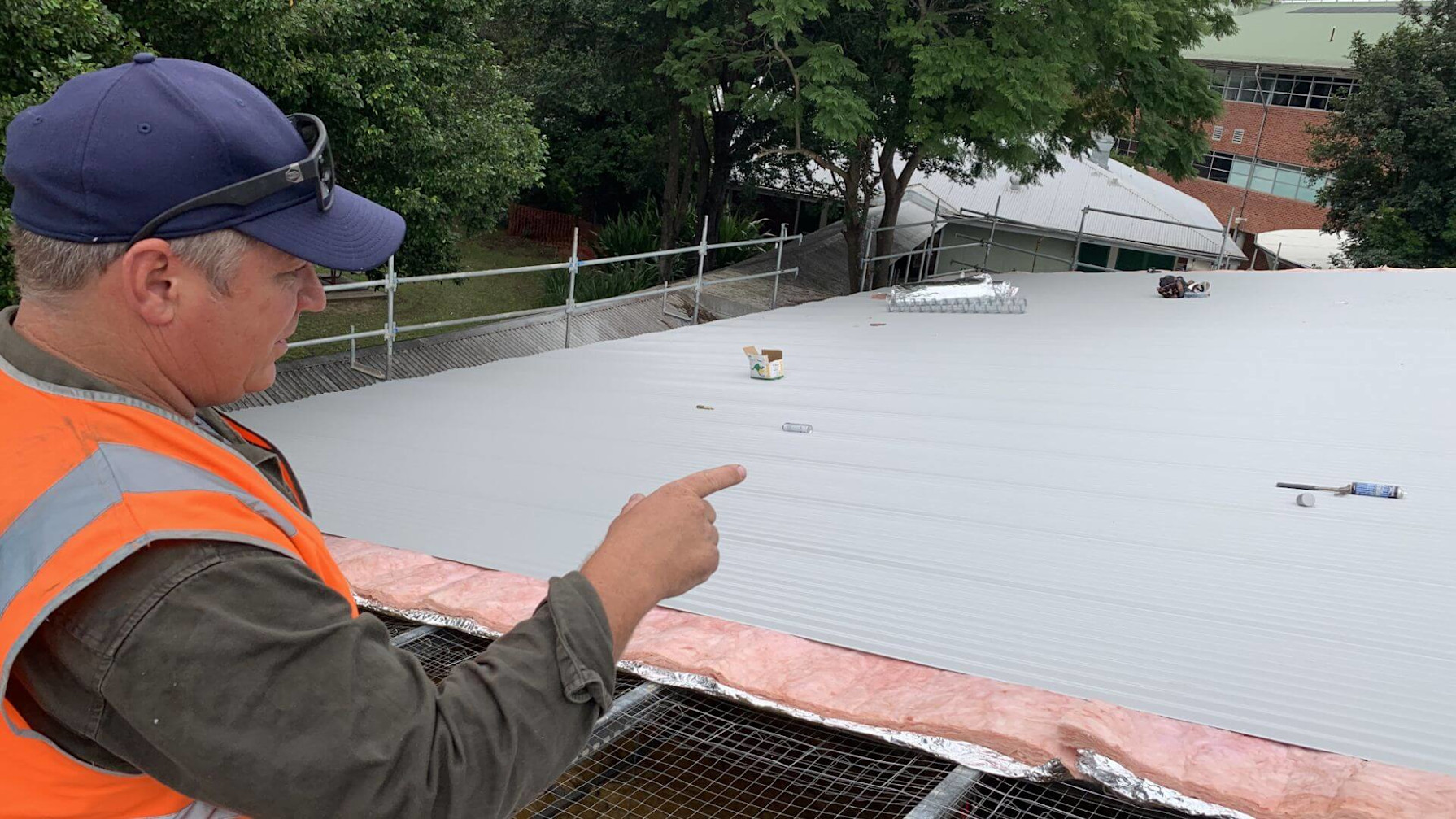 Construction worker inspecting a roof