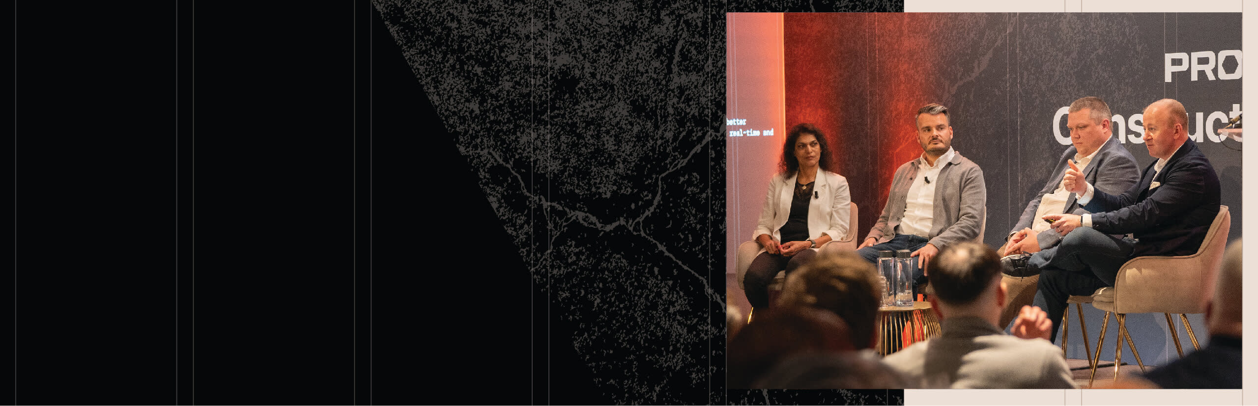 A woman and three man having a conversation on a stage