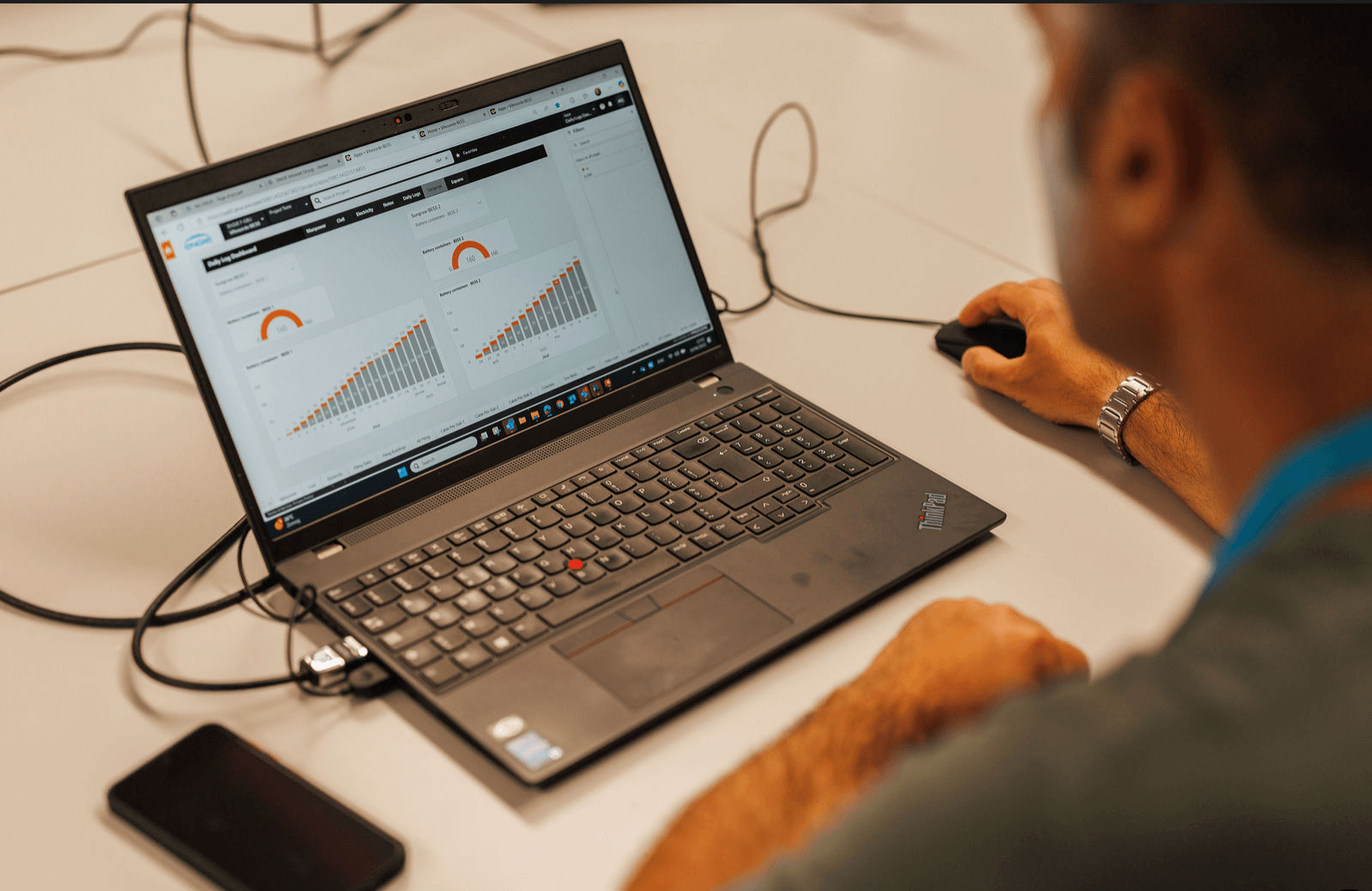 A man looking at graphs on a laptop