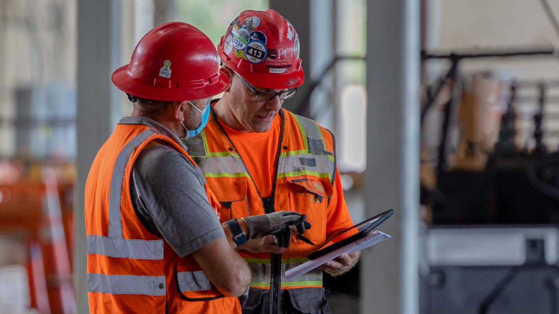Construction Workers collaborate over a mobile device