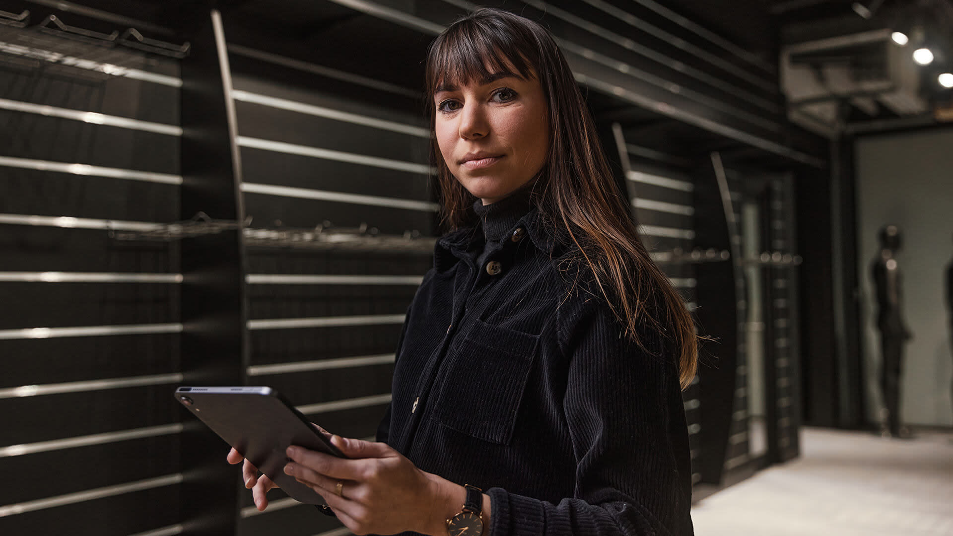 Laptop screen displaying architectural floor plans on a cluttered desk.