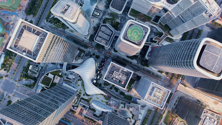 Aerial view of dense urban cityscape with modern buildings and rooftops