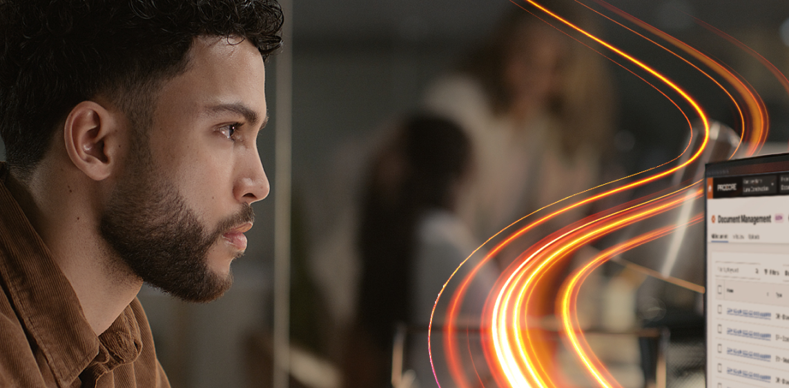 Man looking at a  computer screen with light trails around it