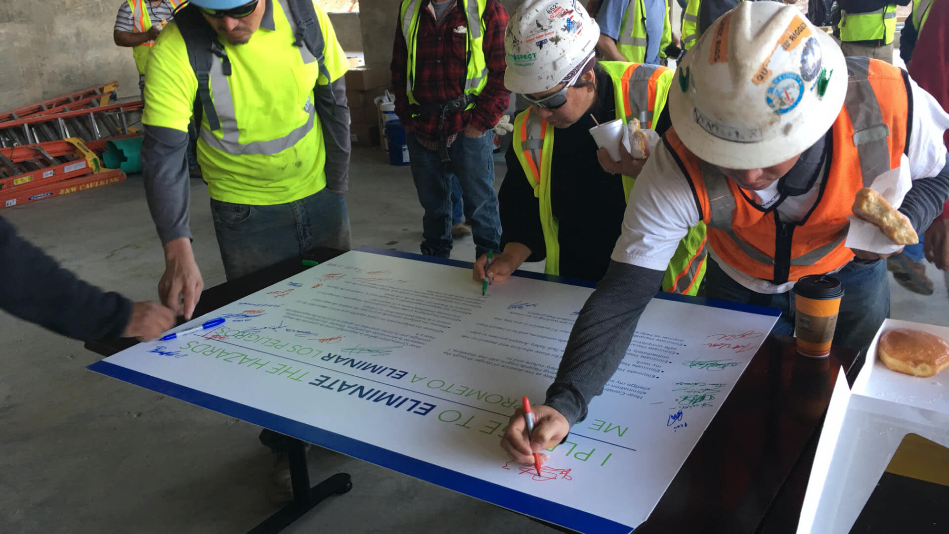 Workers autographing a sign