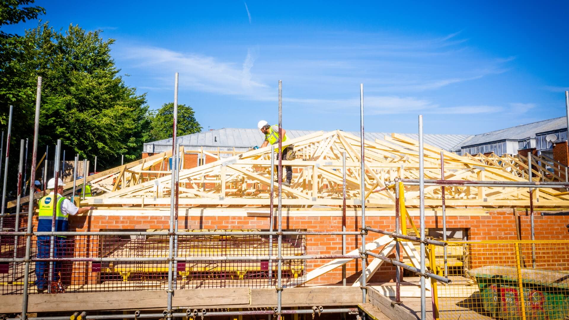 Construction workers building wooden houses