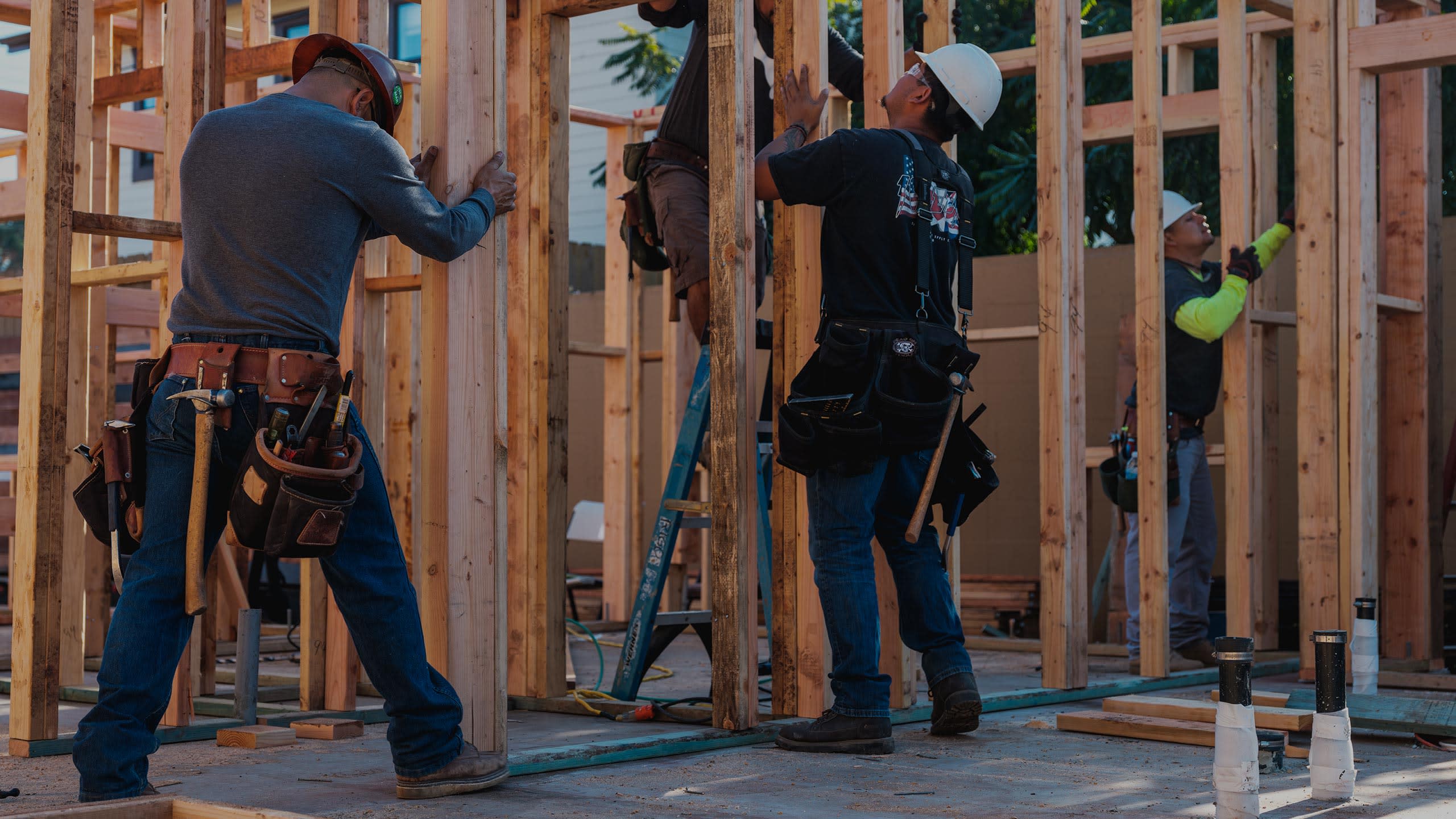 Construction workers putting up wood walls
