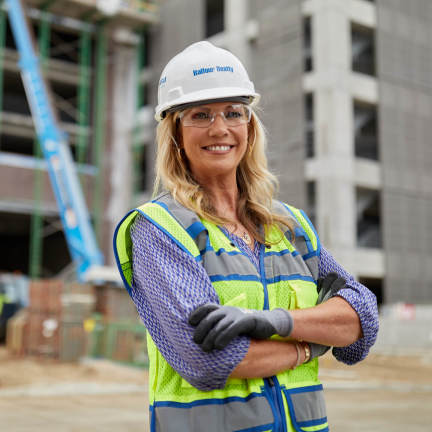 Kasey Bevans posing in front of a construction site