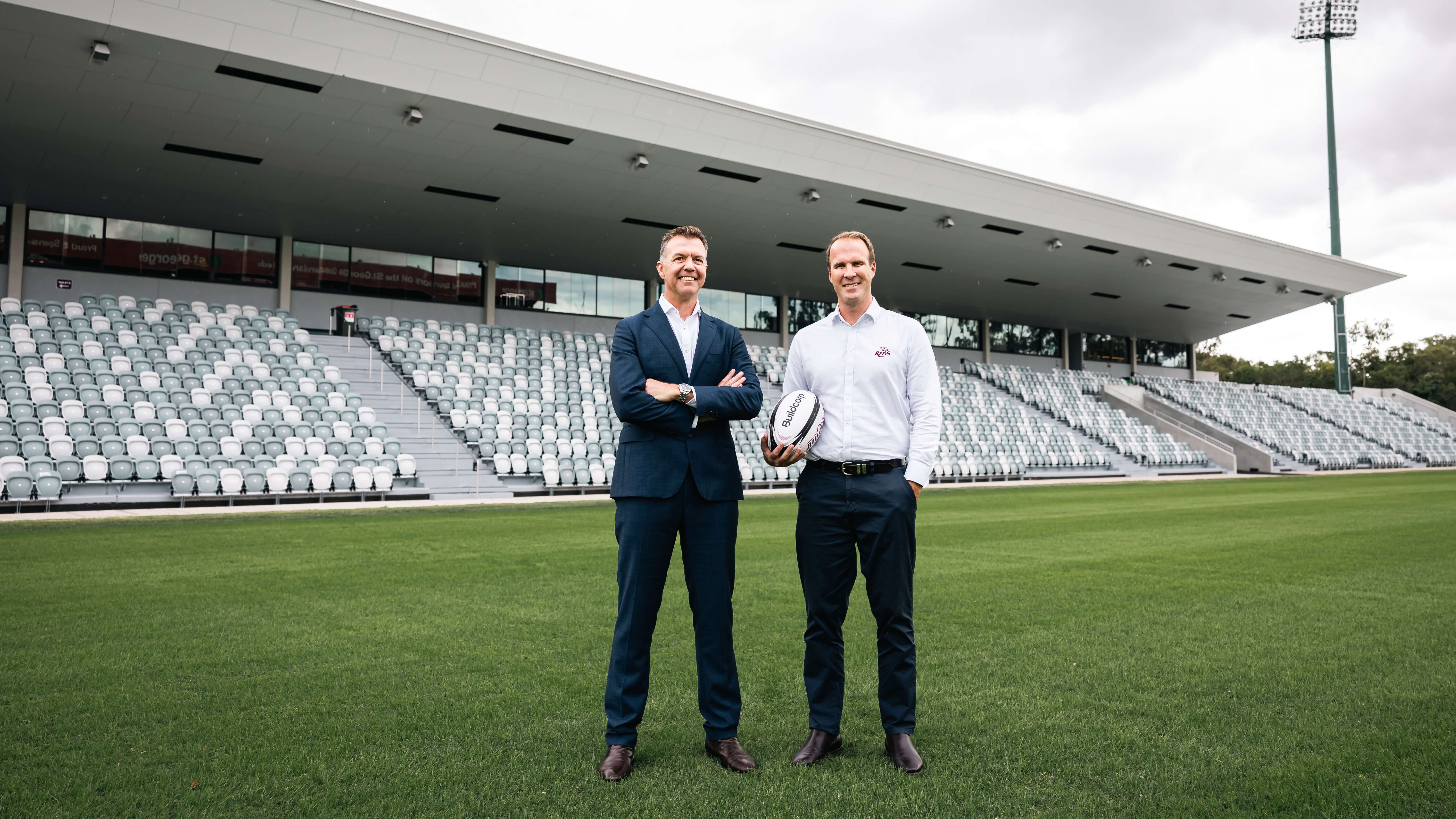 Two men standing on a rugby field