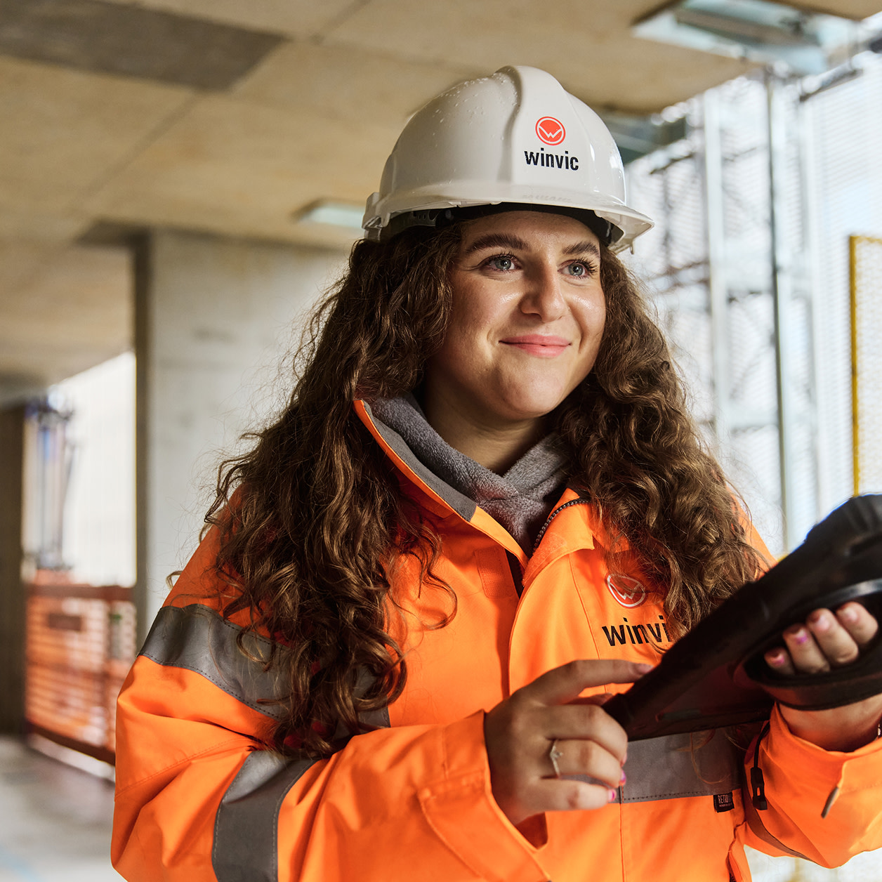 A woman construction worker using a tablet on site