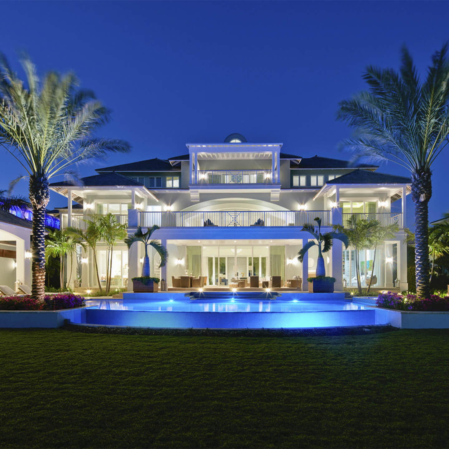 Luxury house's backyard and pool area during night time