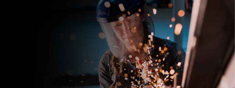 A woman welding a column