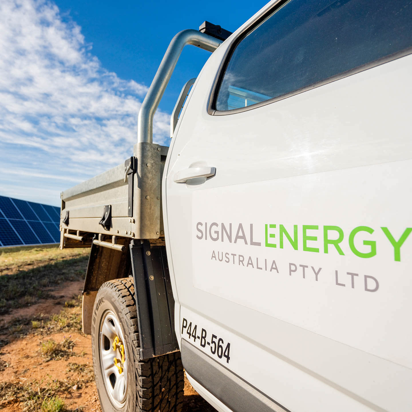 Signal Energy's truck on a solar panel farm