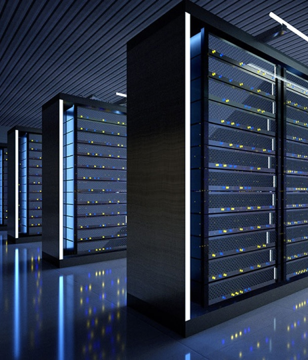 Modern data center server racks with illuminated indicator lights in dark facility