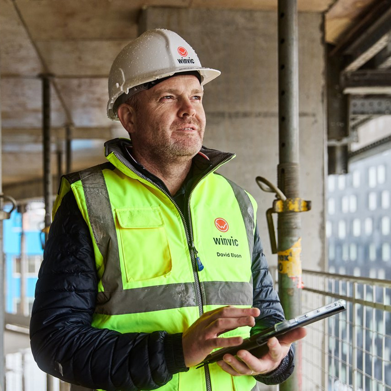 A contractor looking out of a construction site