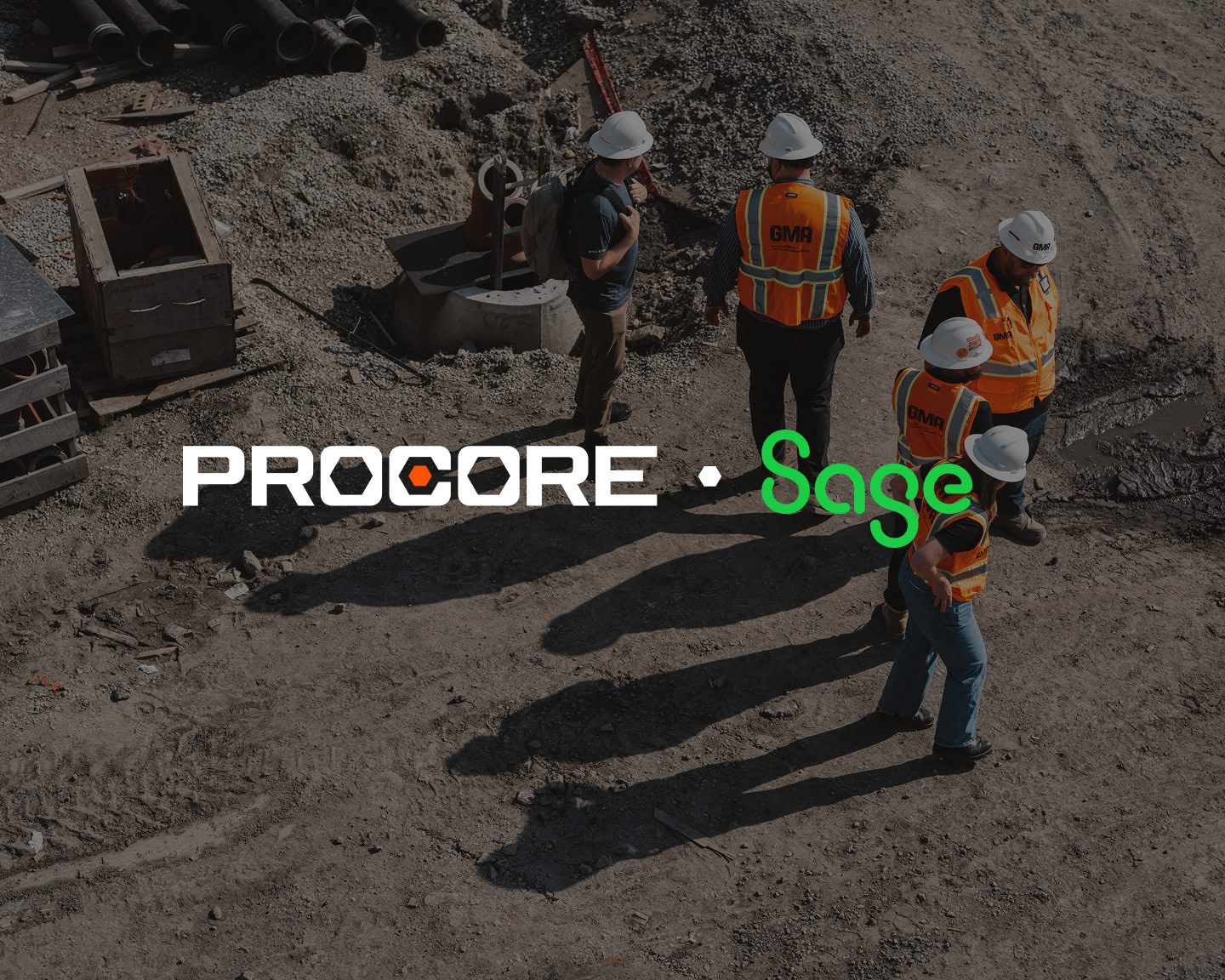Construction workers in orange vests and white helmets standing on a dirt site.