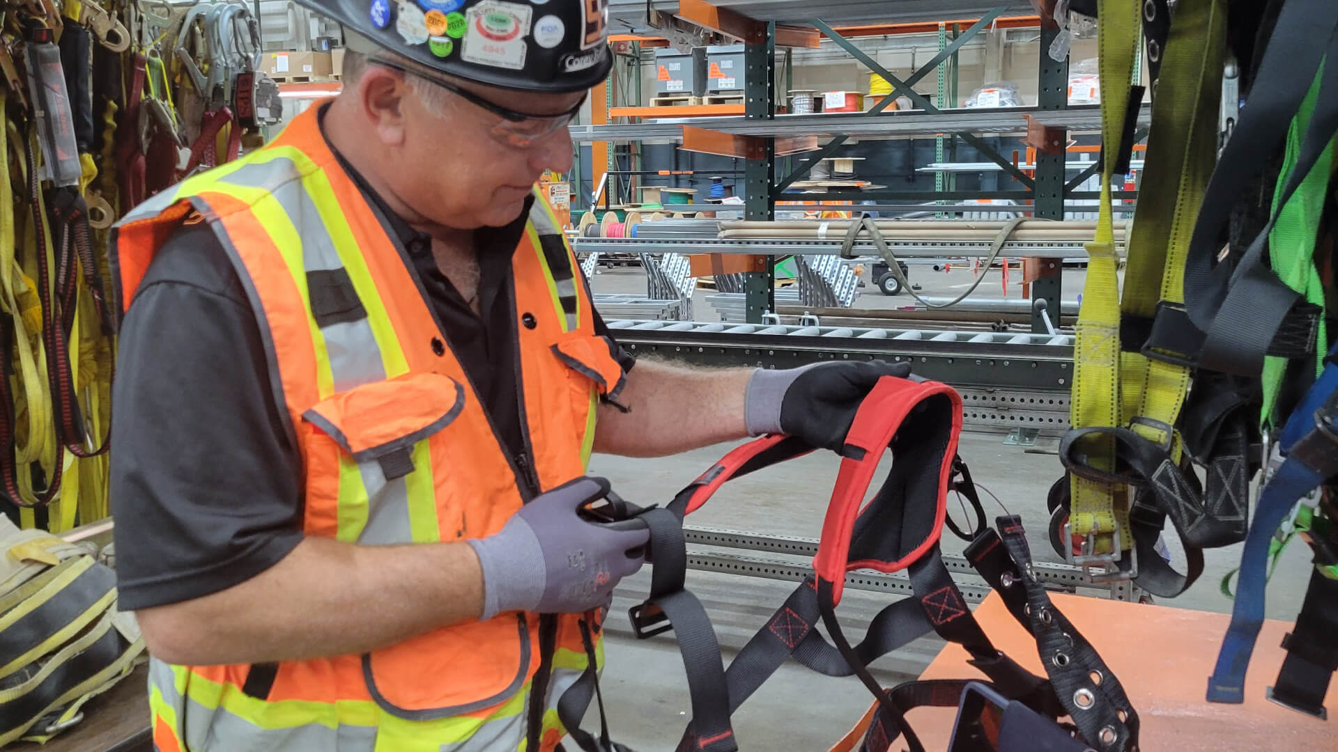 A man wearing a safety vest cutting a vest