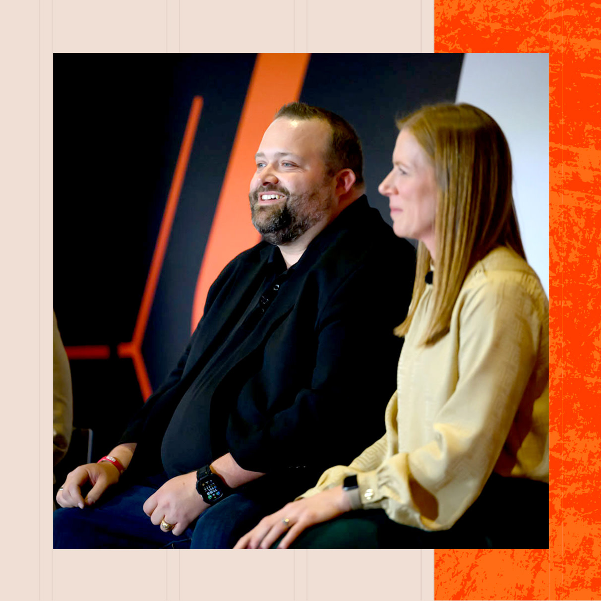 A man and a woman sitting at Groundbreak's stage