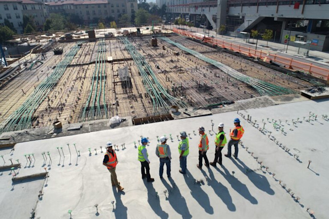 Group of construction workers looking over a construction site