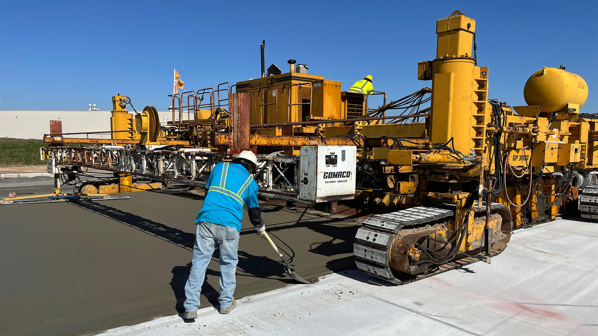 Construction worker flattening cement