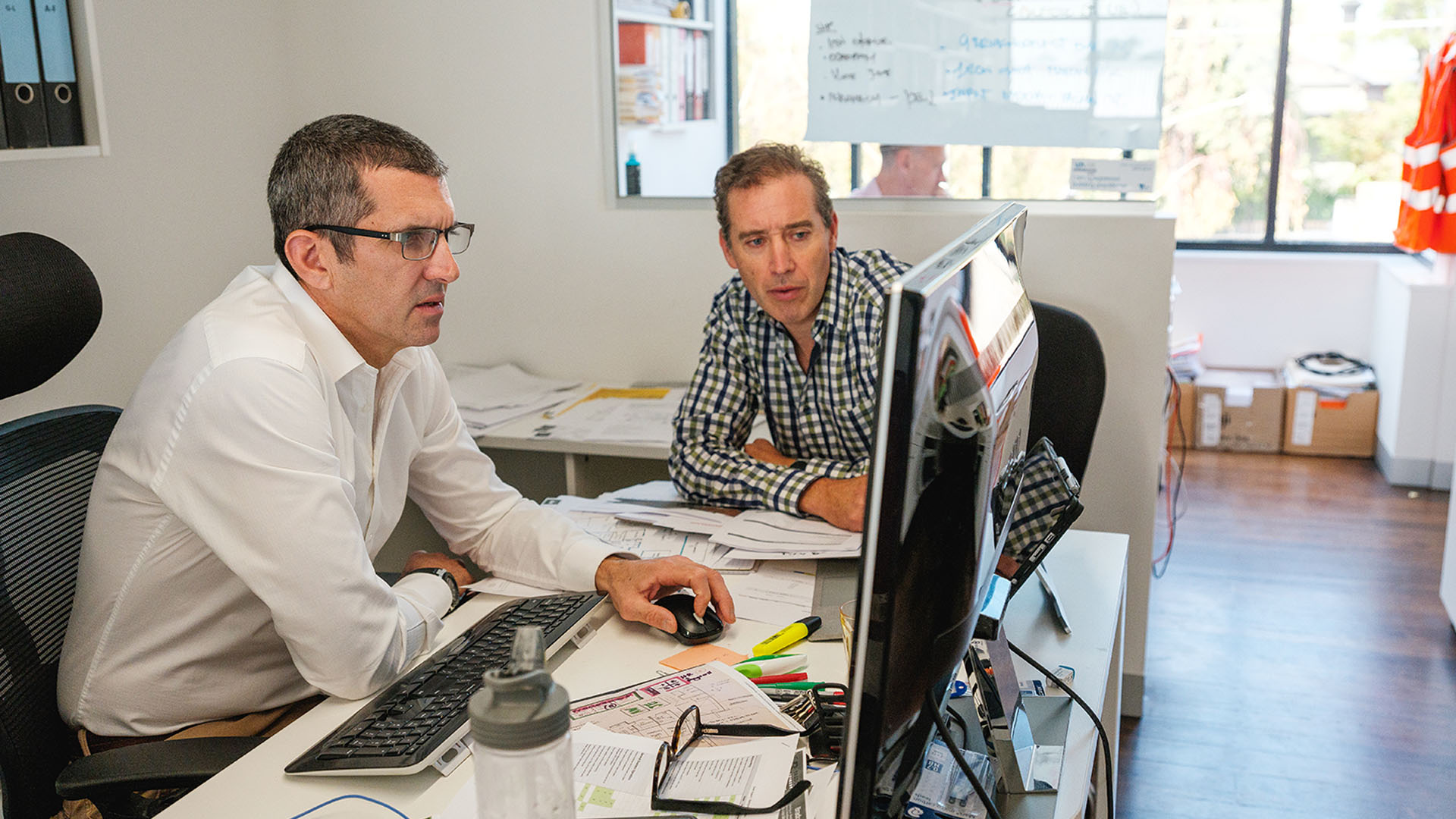 Two men working on a computer