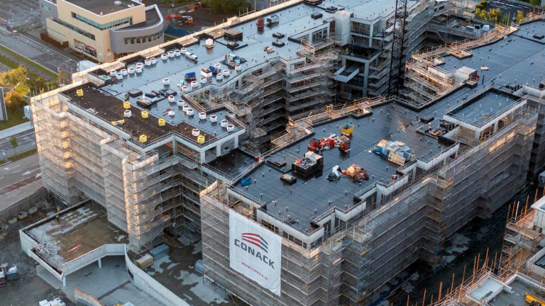 Aerial view of a large building under construction by Conack