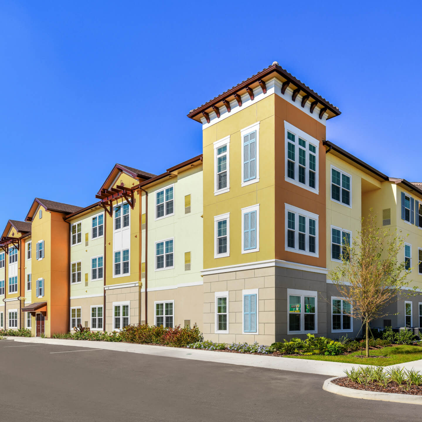 Low angle view of a white and yellow apartment complex