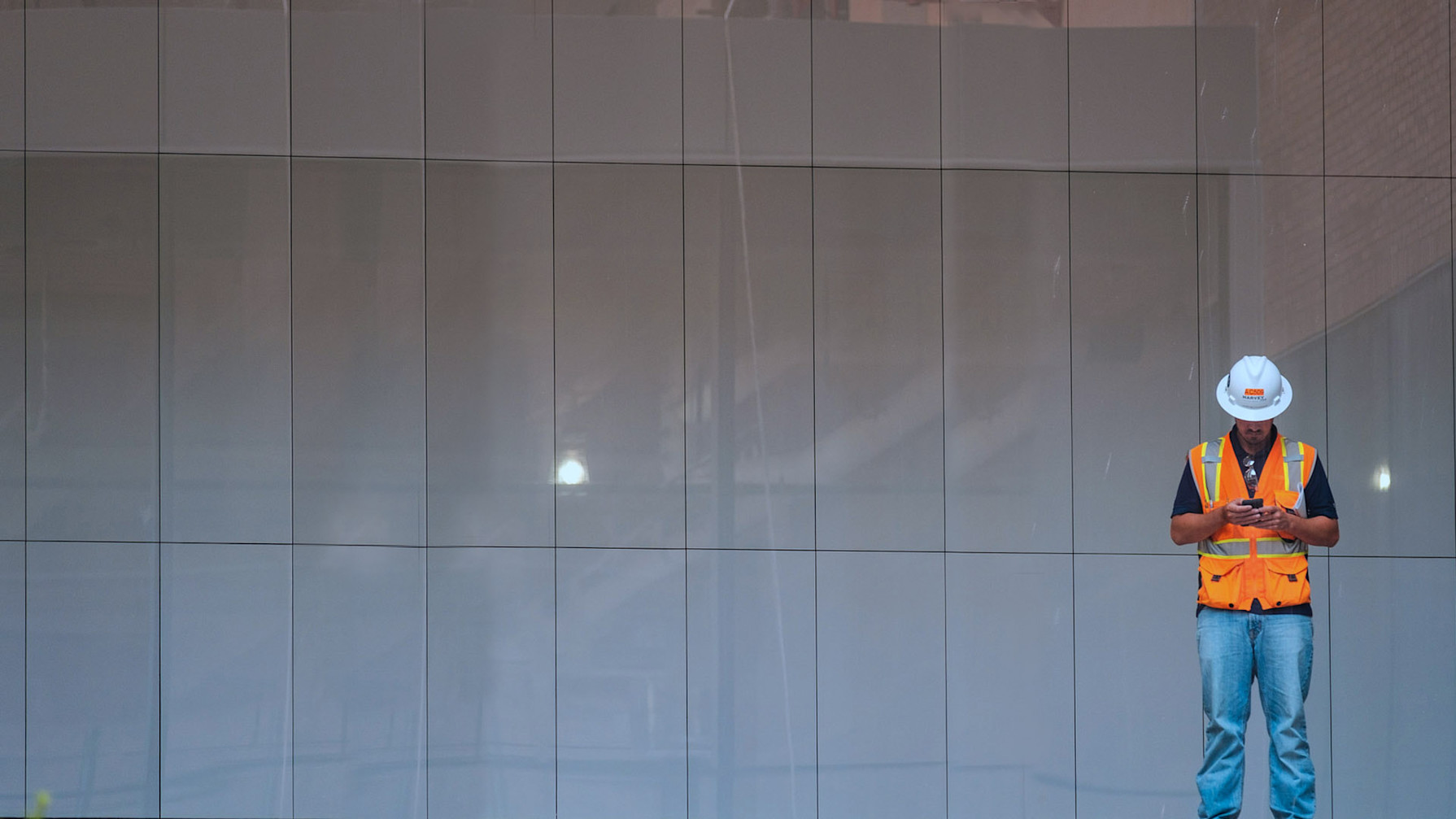 Contractor looking down at his phone