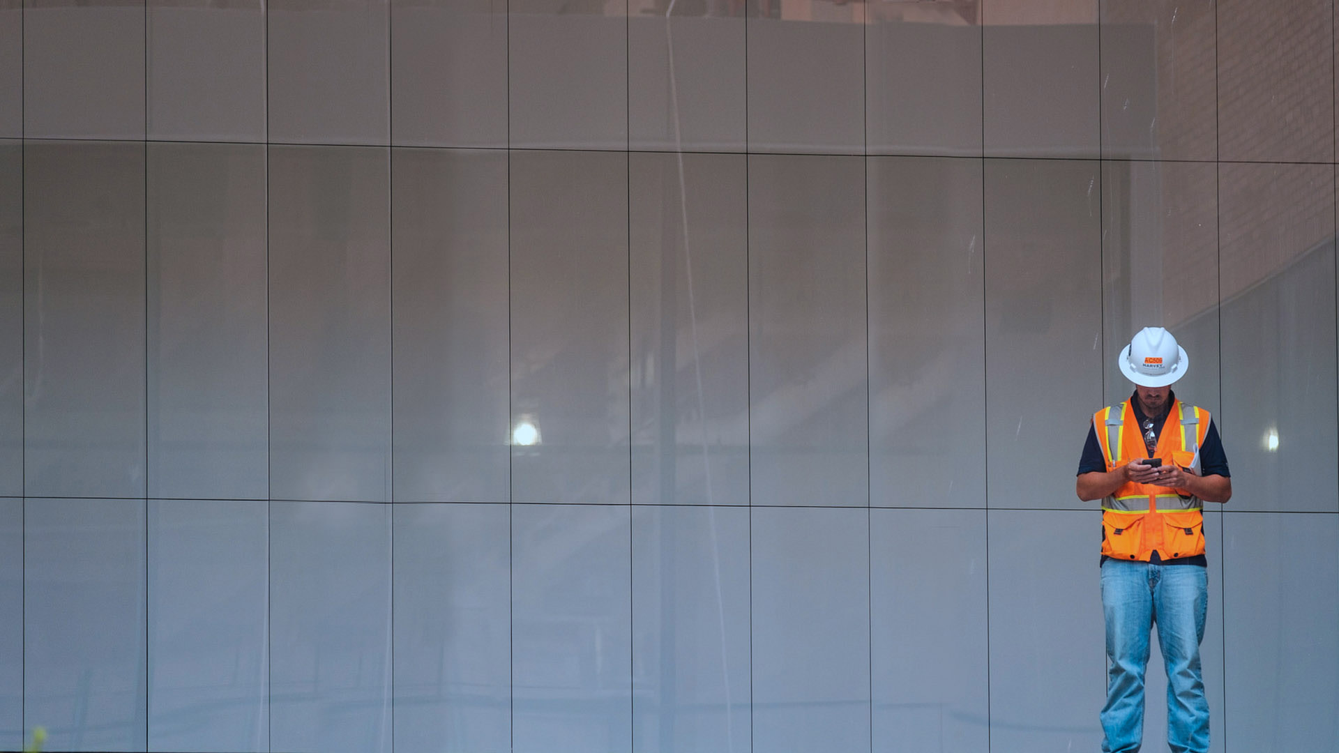 Contractor looking down at his phone