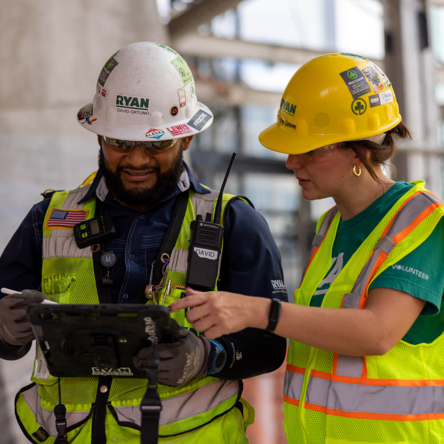 two contractors using a tablet on a construction site