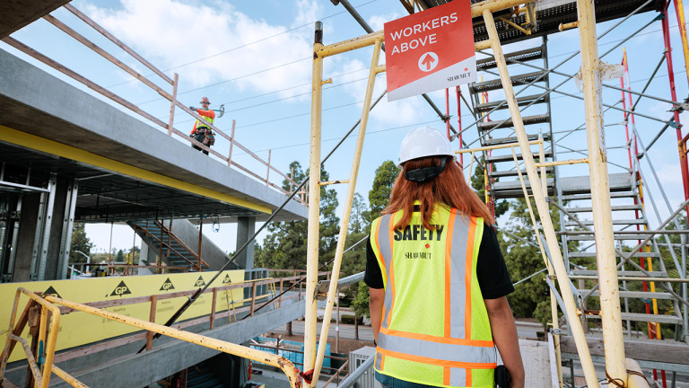 A construction worker walking in a construction site