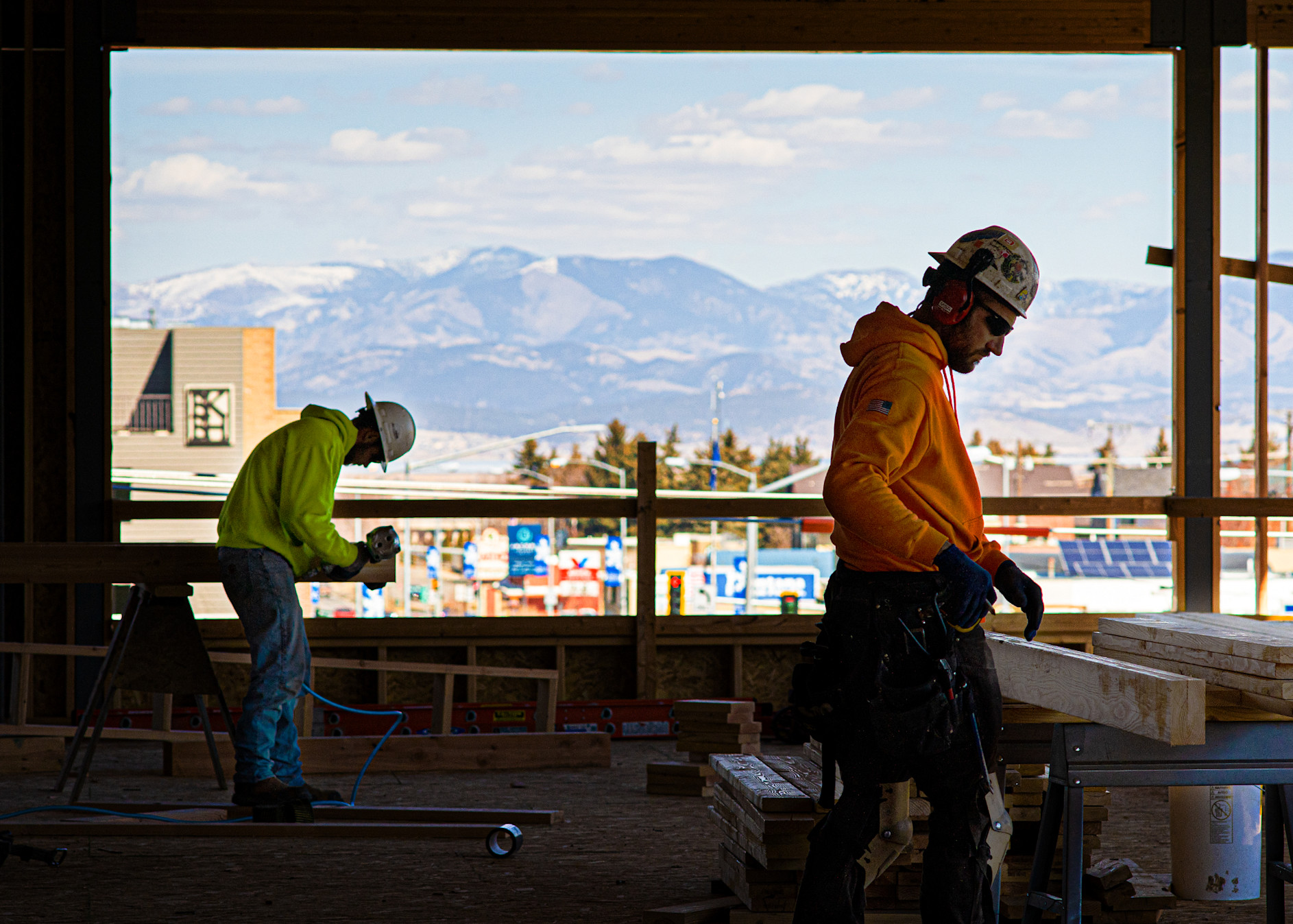 Dick Anderson employee cutting lumber with mountains in the background